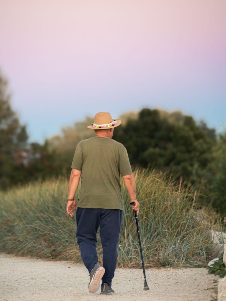 Person walking outdoors in nature, illustrating how everyday routines for trauma recovery can include gentle movement and time outside.