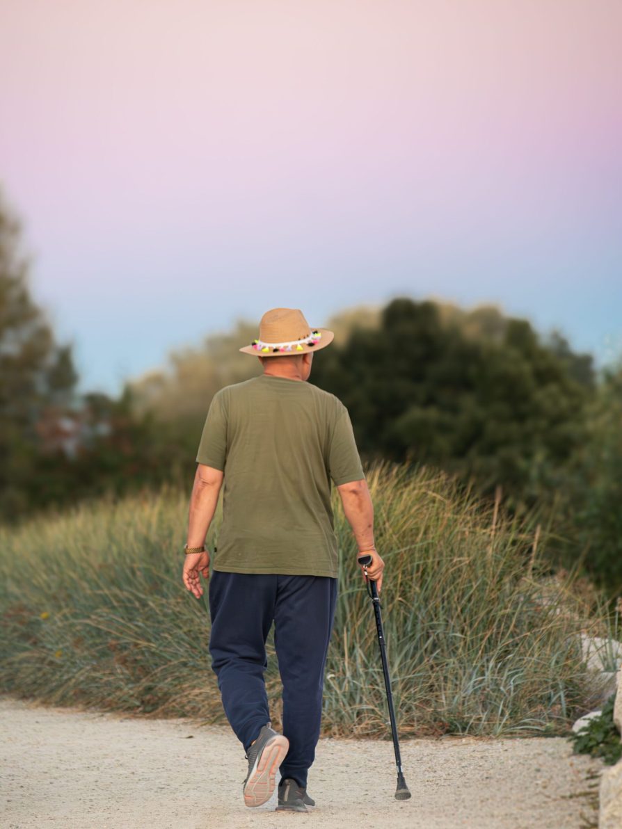 Everyday Routines for Trauma Recovery: Movement and Nature Person walking outdoors in nature, illustrating how everyday routines for trauma recovery can include gentle movement and time outside.