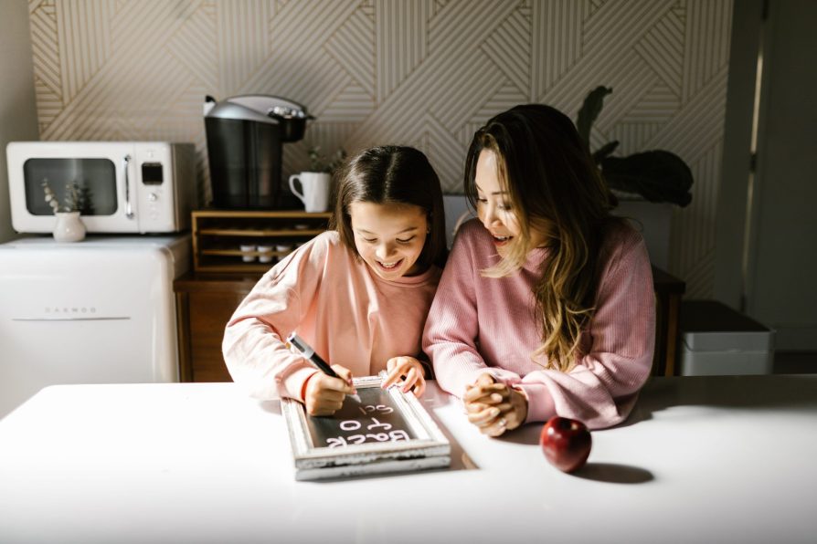Strengthening Family BoDuring Back-to-School Parent and child spending quality time together at the kitchen table during back-to-school, strengthening family bonds through connection and shared learning.